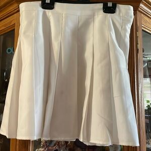 Large pleated white mini skirt.